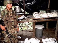 A Colombian soldier guards a haul of cocaine